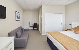 a comfortable couch and flatscreen TV in the room